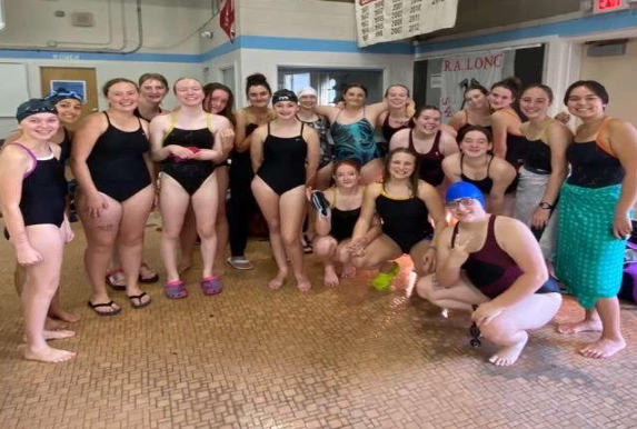 Girls from BGHS and PHS pose together for a picture after the first swim meet of the season. 