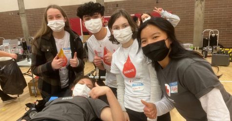 Students of HOSA pose with Melody Brizuela as she donates blood for this years blood drive. 