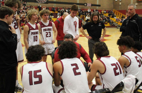 The basketball team gathers before a game to have a pep talk. 
