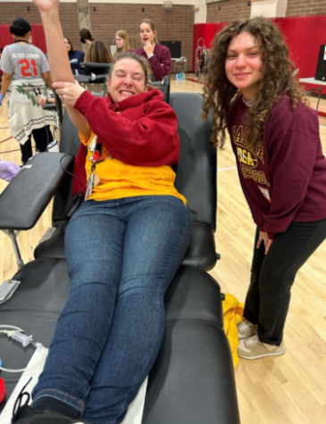 Mrs. Thompson donating blood with Melody Brizuela.