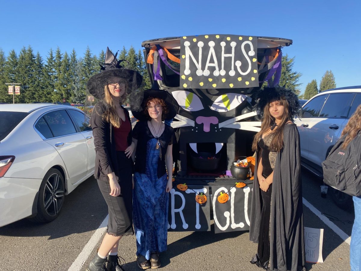 NAHS members dressed up as Witches beside their trunk for Trunk or Treat.