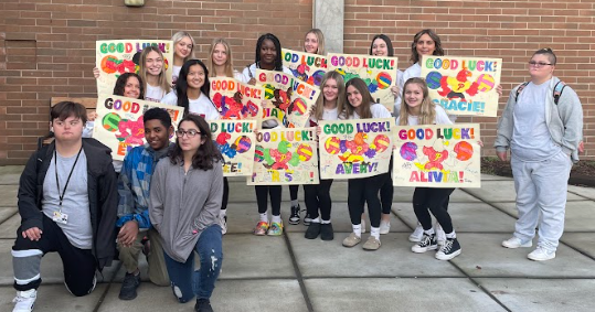 Prairie volleyball at state send off, receiving posters made by Prairie Unified