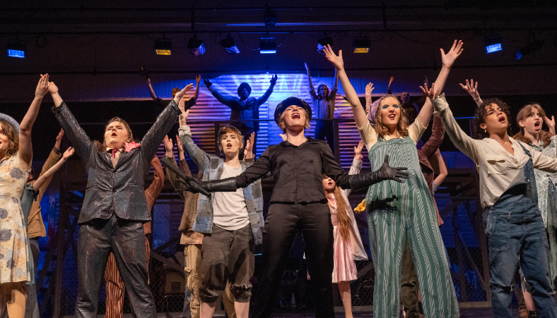 The full cast of Urinetown performs the finale of the show.
