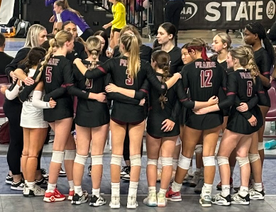 Prairie volleyball huddles together on day 1 on the state tournament, November 17,2023