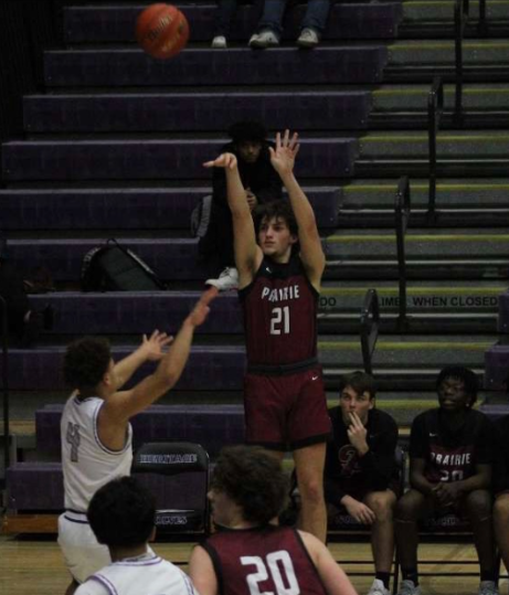 Senior Brendan Carter attempts a three-point shot in a win over Heritage High School on 1/9/2024.