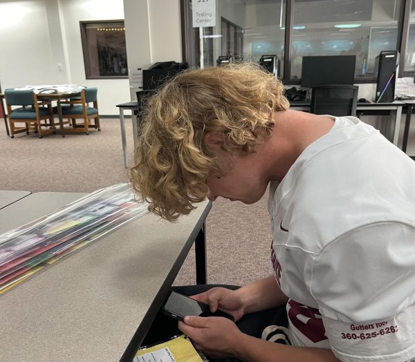 Student using their phone during school hours.