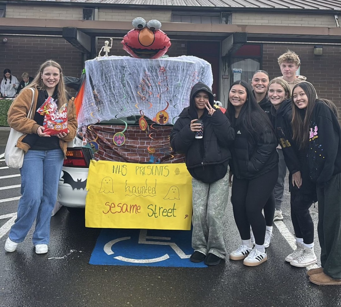 Prairie High School students gather in front of the Sesame Street-themed trunk, decorated by the National Honor Society for this year’s Trunk-or-Treat event