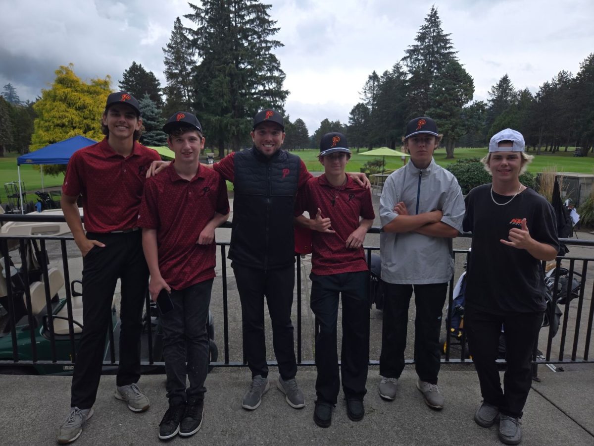 Varsity Boys Golf Team posing after districts at Lewis River Golf Course.