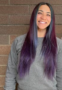 Tori Sharpe poses in front of her new classroom.