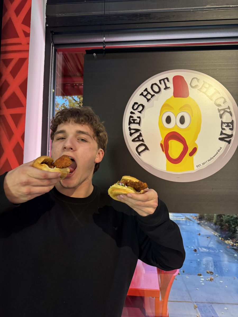 Senior Kaleb Cave posing with his two sliders shortly after ordering