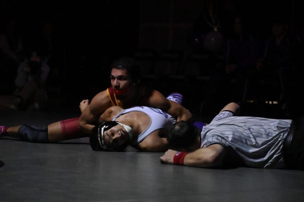 Tommy Vick holding his opponent from Heritage High School for a much needed pin. 