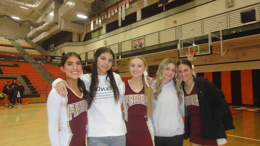 Prairie cheer juniors celebrate with friends, after victory against Battle Ground High School.