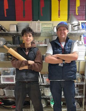 Britt Pedlar and Diego Pelayo posing with culinary utensils