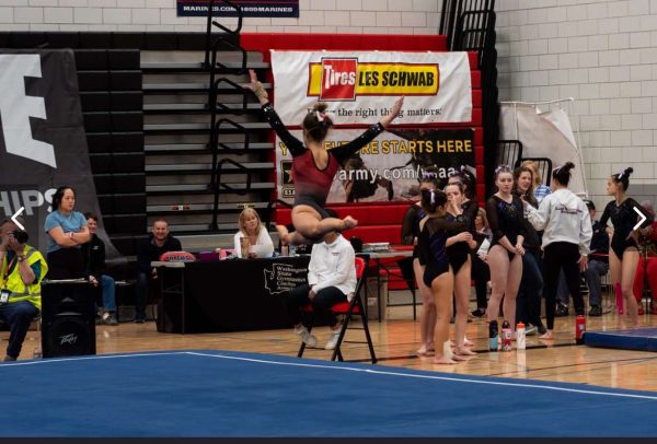 Hayden Wojack performing a switch leap during her floor routine at State 2024 at Sammamish High School. 