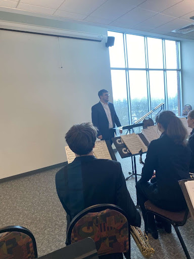 Band Director Ryan Messling rehearses with the band before taking the stage. 
