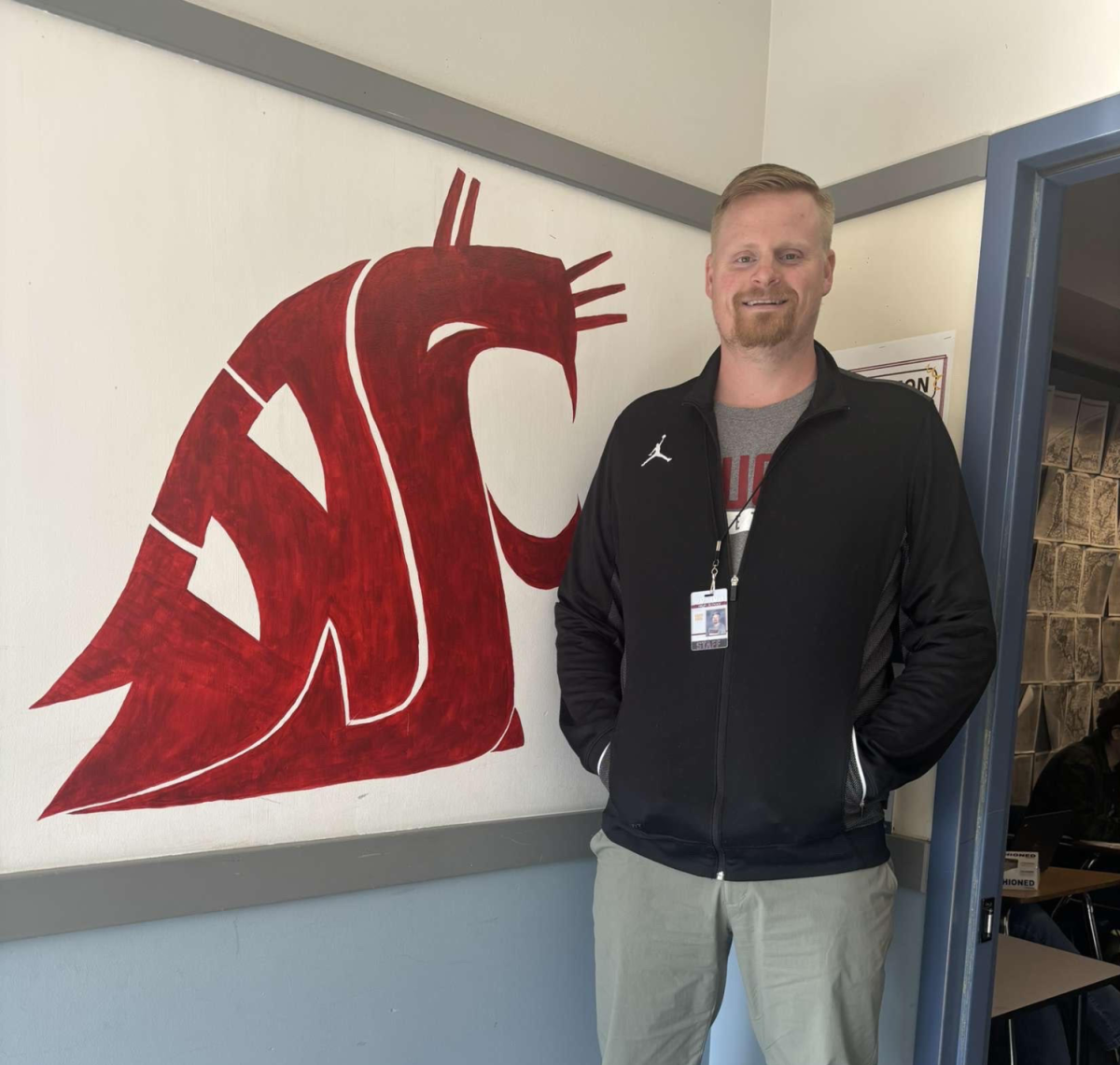 Steven Bjornstad standing for a picture in front of his classroom.
