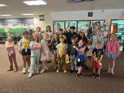 A group of kids brought to take you kid to work day in the library.