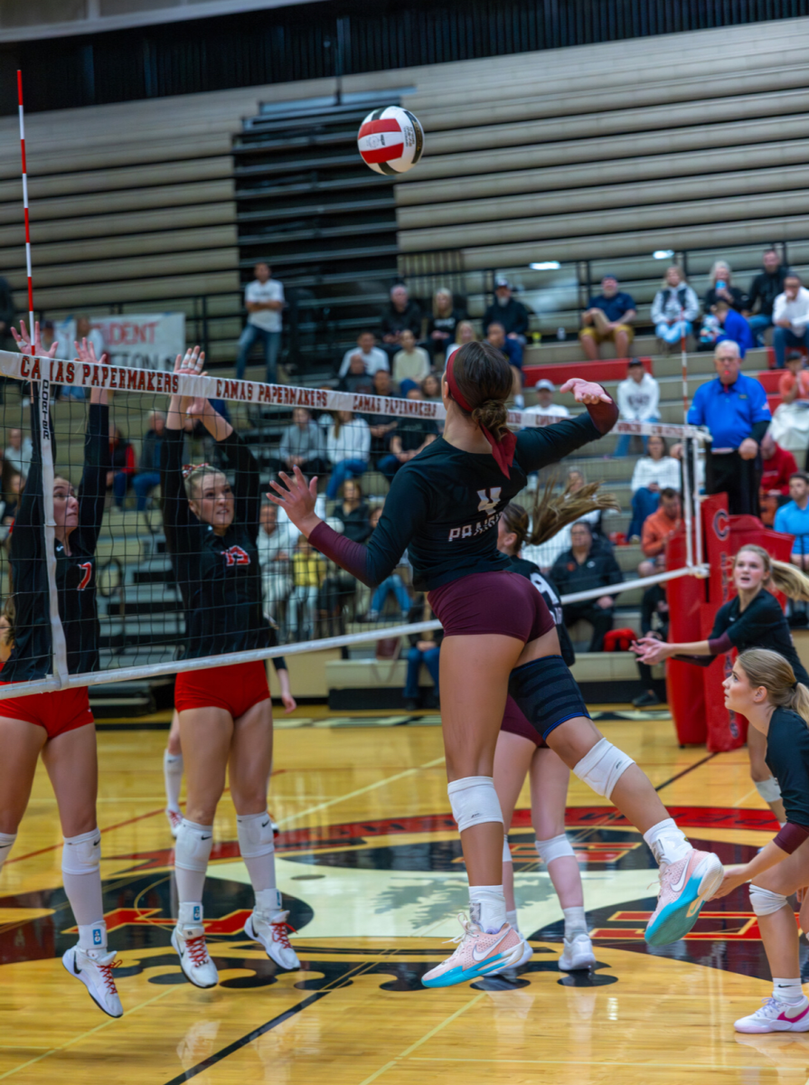 Gracie Jacoby attempts to swing over block against Camas Papermakers, Jeremiah Stephen captures in action