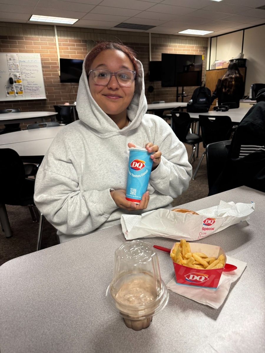 “Student Justyne Glover with a warm smile, enjoying her meal from Dairy Queen after lunch.”