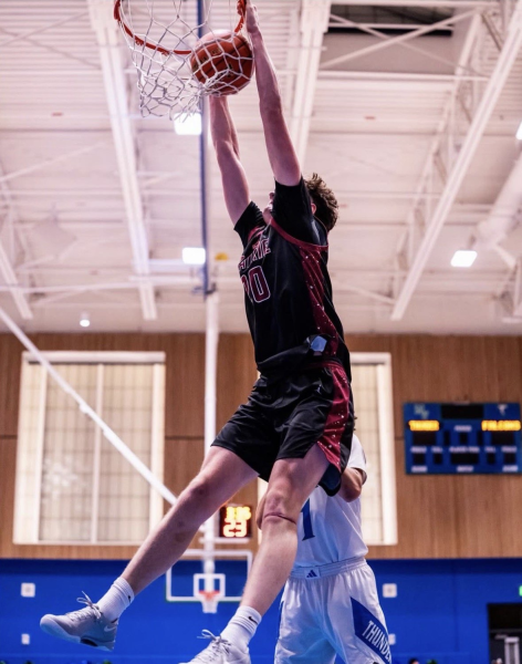 Carson Morningstar, number 20, goes to dunk against Mountain View defender.

