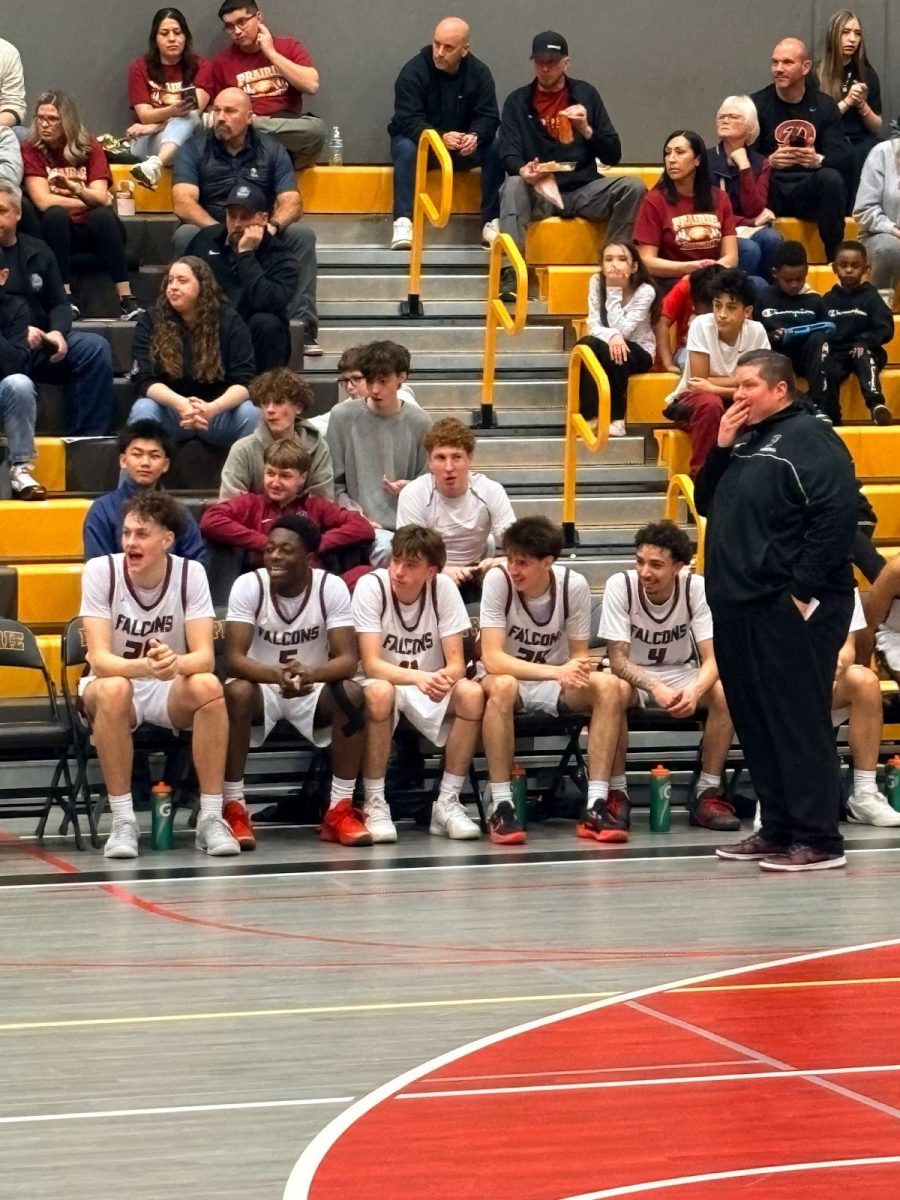 Deep in thought, Coach T strategizes from the bench, his watchful eye on every play. During the heritage verse, Prairie during senior night.


