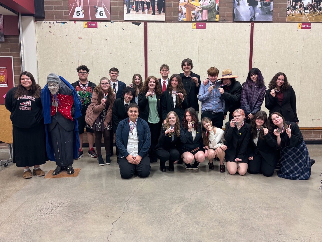 All the speech and debate team posing with medals after the debate meet at prairie high school.