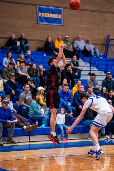 Griffin Smith, number 24, goes up for a jumpshot against Kelso defender.
