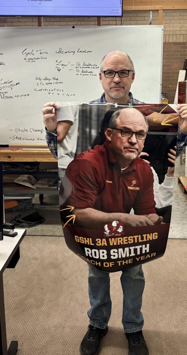 Double coach Smith Rob Smith is holding up his poster from last year of getting GSHL 3A coach of the year.
