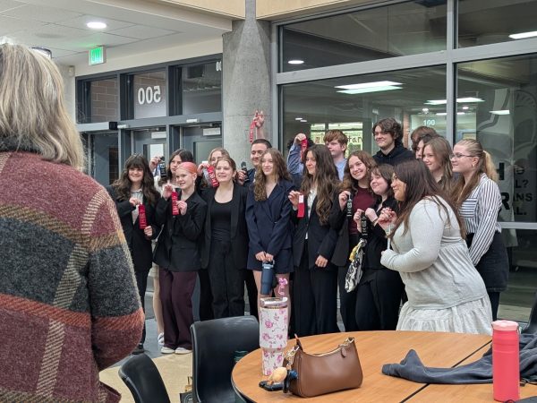Speech and Debate Club holding awards after competition. 