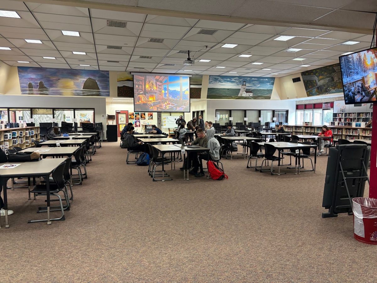 Prairies library, with students working in groups or alone.
