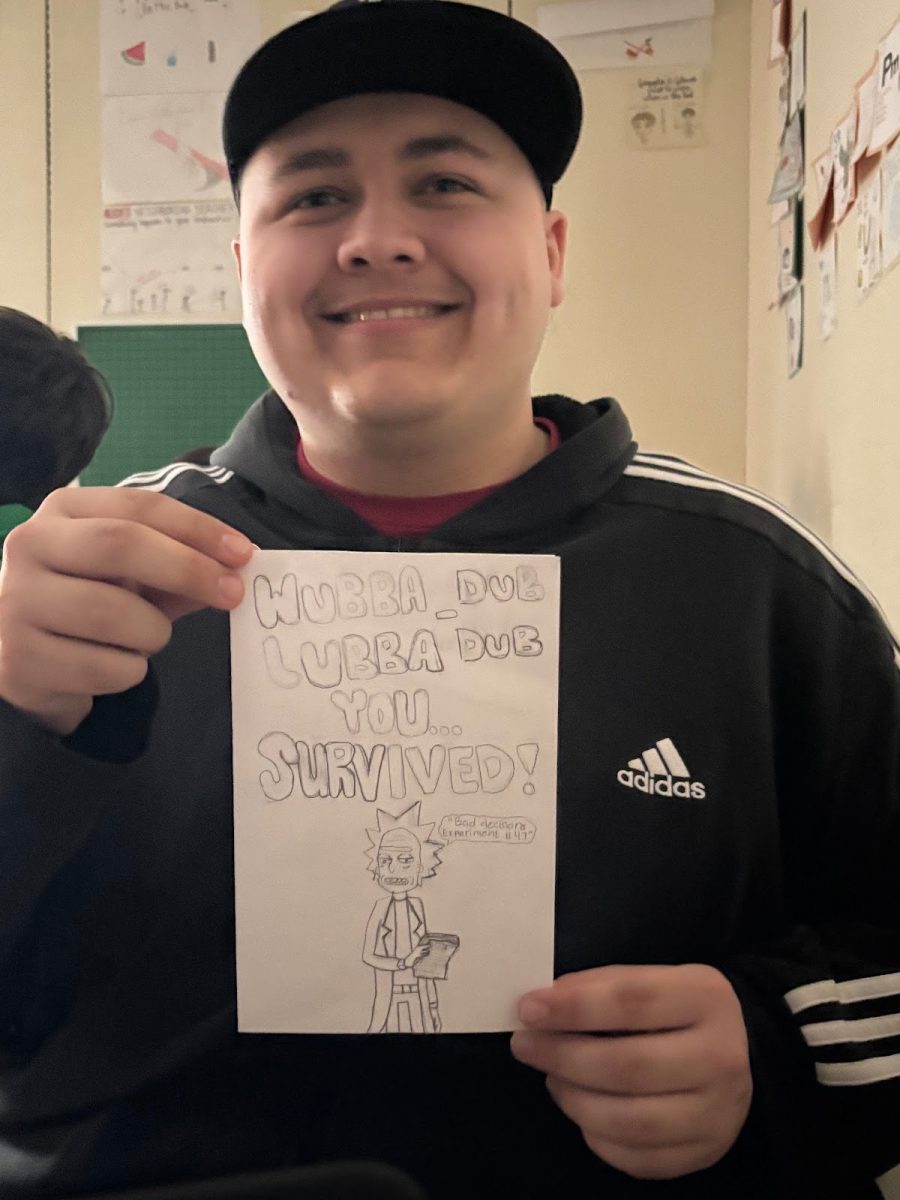 Student Jaydyn Johnson holding a card he made with his art skills for a friend of his. 
