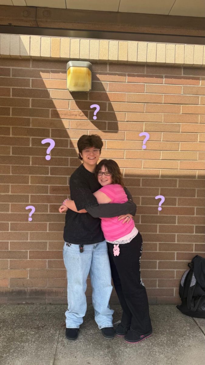 Josiah and Kaya hugging in the hall. 
